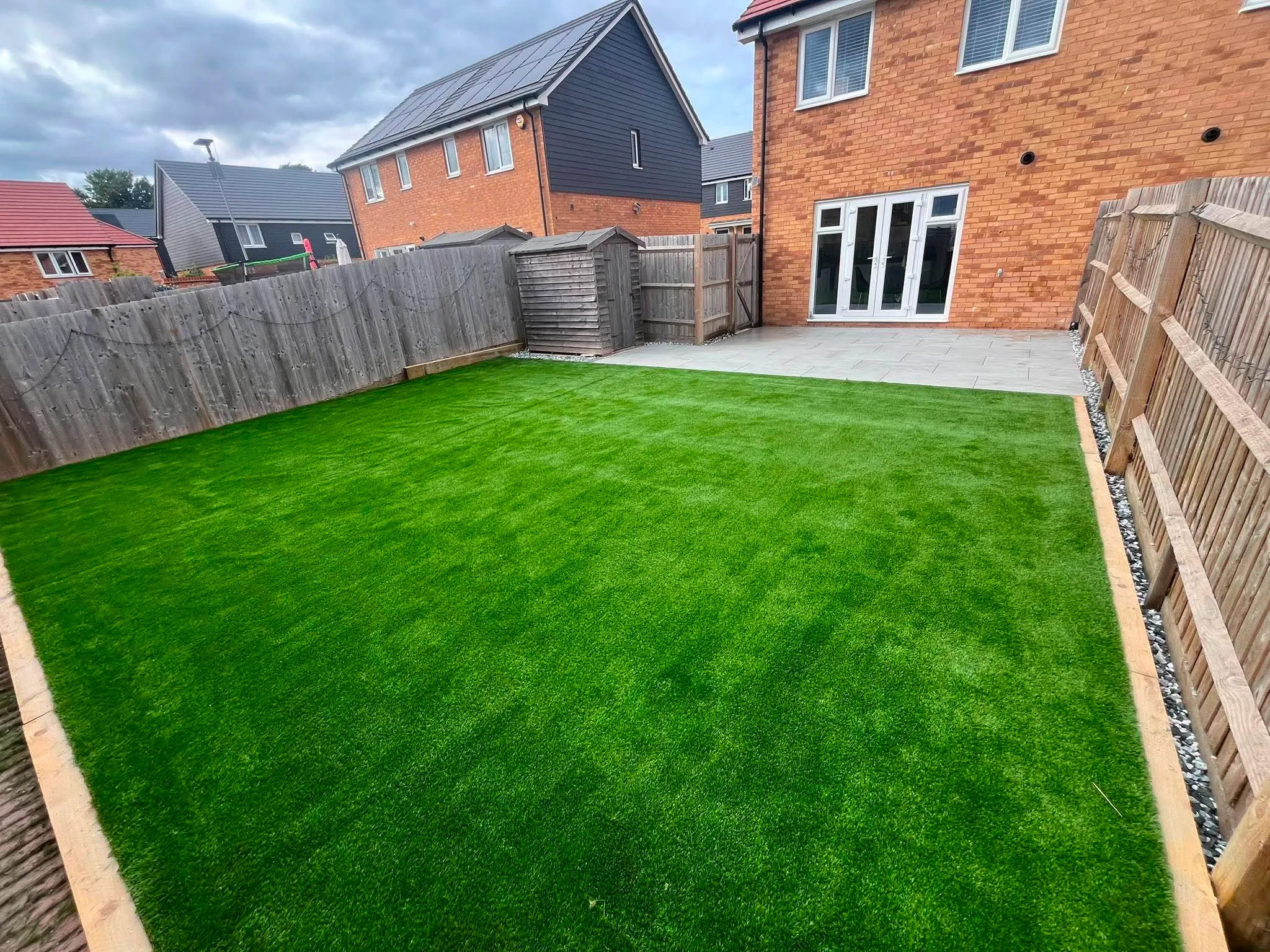Artificial lawn and modern patio installation
