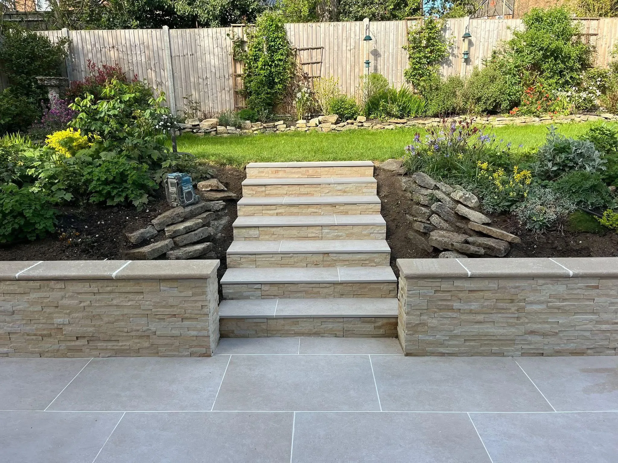 Stone clad retaining wall with steps
